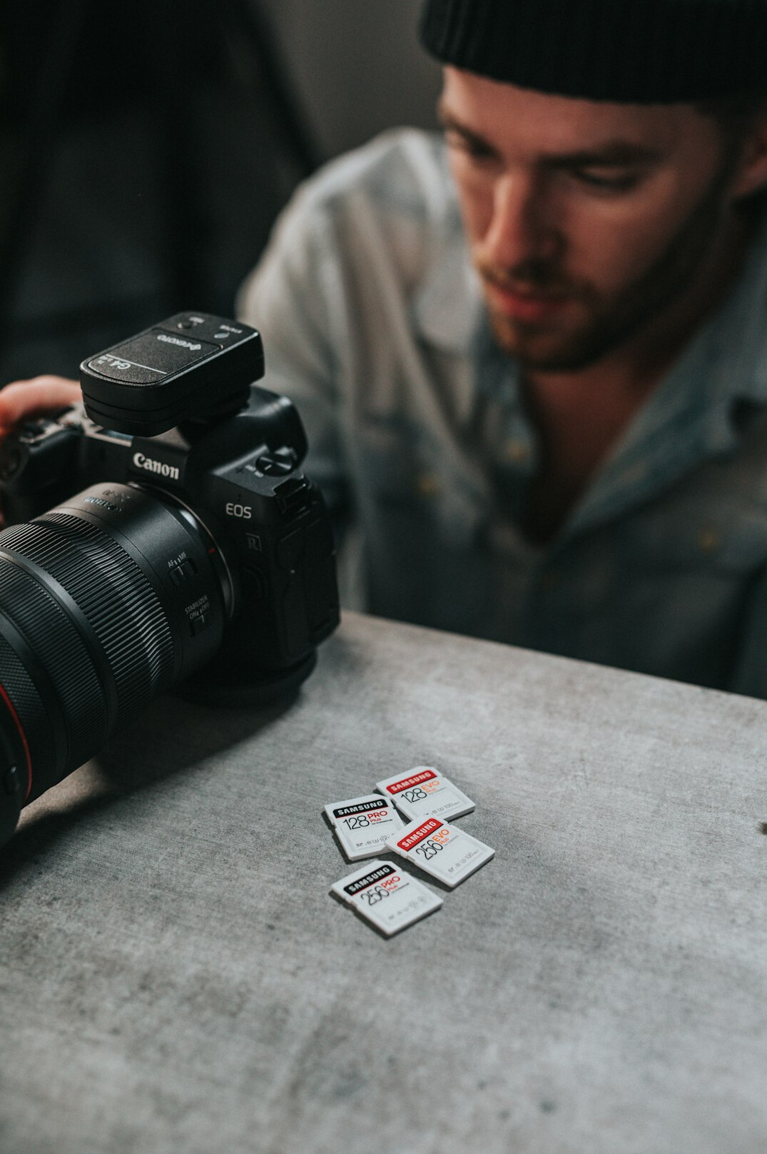 Photographer reviewing photos on a laptop with camera nearby